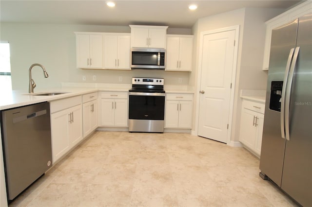 kitchen with light countertops, a sink, white cabinetry, and appliances with stainless steel finishes