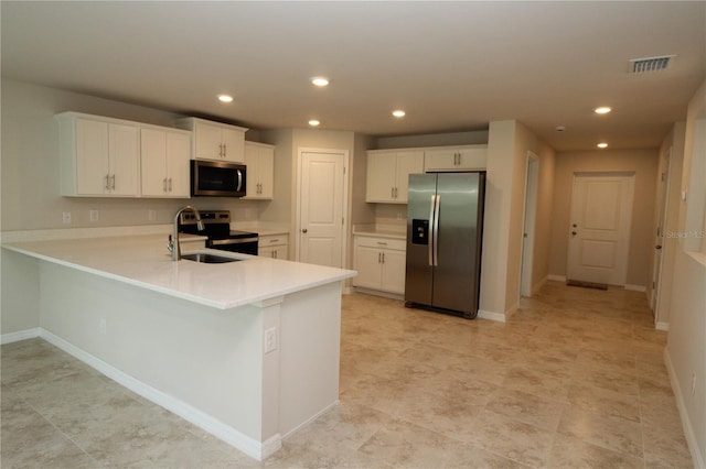 kitchen featuring visible vents, light countertops, a peninsula, recessed lighting, and stainless steel appliances