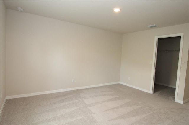 spare room with light carpet, baseboards, visible vents, and recessed lighting