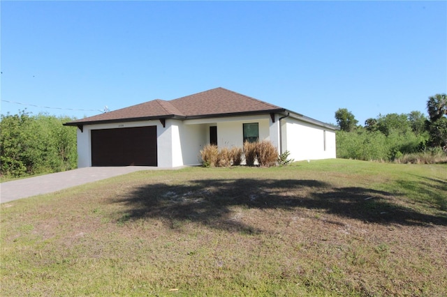 single story home featuring a garage, stucco siding, driveway, and a front yard