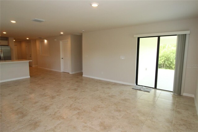 17374 Gadsen Ave, Port Charlotte, FL 33948 - unfurnished living room featuring recessed lighting, light tile patterned floors, and baseboards
