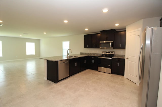 4071 Conestoga St, Port Charlotte, FL 33948 - kitchen featuring a sink, open floor plan, appliances with stainless steel finishes, recessed lighting, and light stone counters