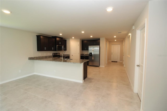 4071 Conestoga St, Port Charlotte, FL 33948 - kitchen with stone countertops, recessed lighting, a peninsula, light tile patterned flooring, and stainless steel appliances