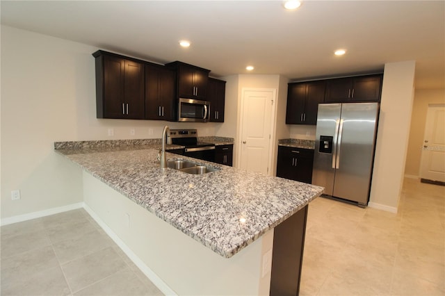 4071 Conestoga St, Port Charlotte, FL 33948 - kitchen with a peninsula, recessed lighting, appliances with stainless steel finishes, light stone counters, and baseboards