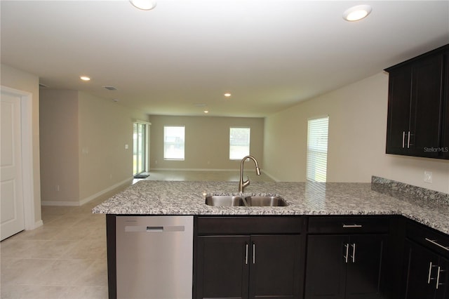 4071 Conestoga St, Port Charlotte, FL 33948 - kitchen featuring light stone counters, a peninsula, open floor plan, stainless steel dishwasher, and a sink