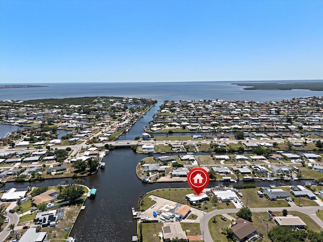 drone / aerial view with a water view and a residential view