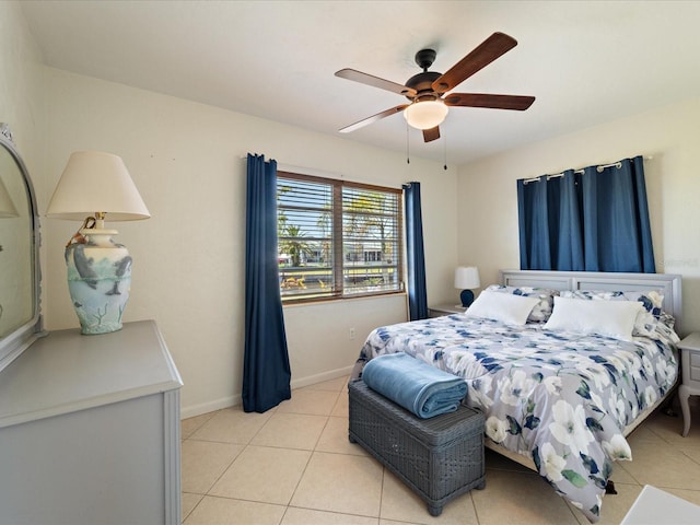 bedroom with light tile patterned floors, baseboards, and a ceiling fan