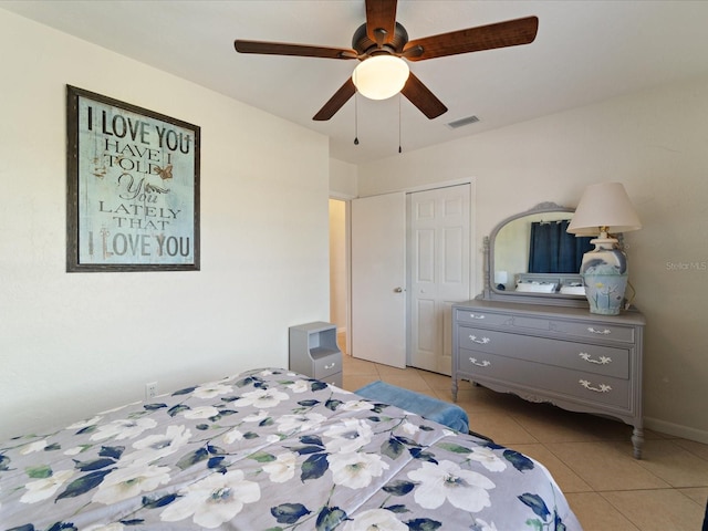 bedroom featuring visible vents, a ceiling fan, a closet, and light tile patterned flooring