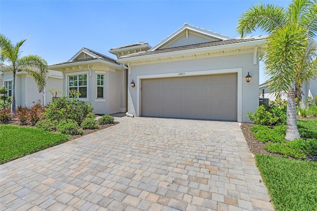 14413 Heritage Landing Blvd, Punta Gorda, FL 33955 - ranch-style home featuring stucco siding, decorative driveway, and a garage