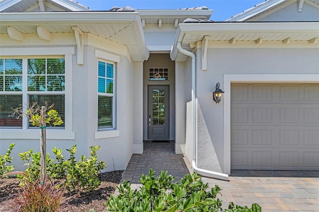 14413 Heritage Landing Blvd, Punta Gorda, FL 33955 - property entrance featuring stucco siding and a garage