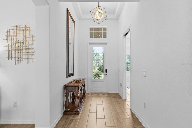 14413 Heritage Landing Blvd, Punta Gorda, FL 33955 - entrance foyer featuring light wood-style floors, a chandelier, and baseboards