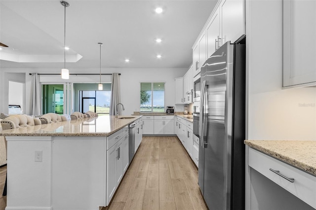 14413 Heritage Landing Blvd, Punta Gorda, FL 33955 - kitchen with stainless steel appliances, light wood-type flooring, white cabinetry, a spacious island, and recessed lighting