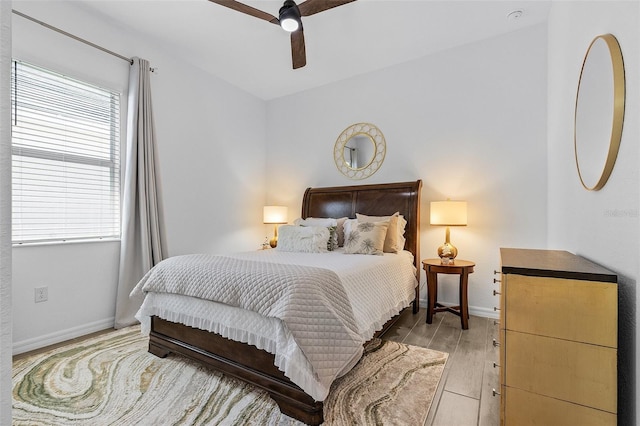 14413 Heritage Landing Blvd, Punta Gorda, FL 33955 - bedroom featuring multiple windows, light wood-style floors, baseboards, and a ceiling fan