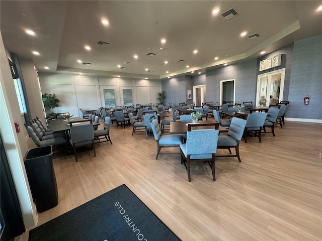 14413 Heritage Landing Blvd, Punta Gorda, FL 33955 - dining area featuring light wood-style floors, a tray ceiling, recessed lighting, and baseboards