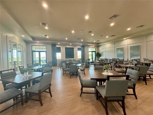 14413 Heritage Landing Blvd, Punta Gorda, FL 33955 - dining room with light wood-style flooring, recessed lighting, and a decorative wall