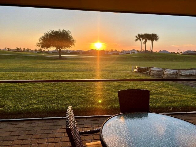 14413 Heritage Landing Blvd, Punta Gorda, FL 33955 - patio terrace at dusk featuring a yard