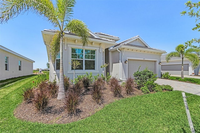 14413 Heritage Landing Blvd, Punta Gorda, FL 33955 - ranch-style home featuring a front lawn, stucco siding, a garage, and decorative driveway