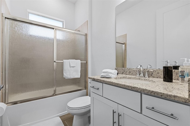 14413 Heritage Landing Blvd, Punta Gorda, FL 33955 - bathroom featuring vanity, shower / bath combination with glass door, toilet, and wood finished floors