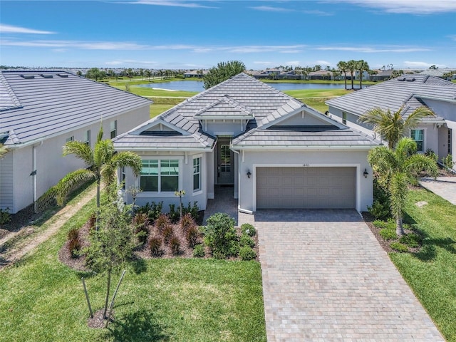 14413 Heritage Landing Blvd, Punta Gorda, FL 33955 - single story home featuring an attached garage, decorative driveway, a water view, and a front yard