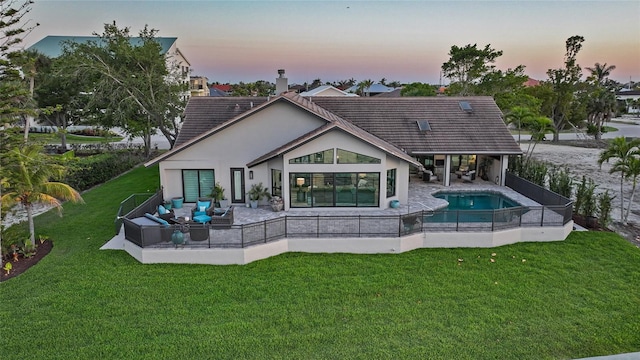 1820 Jamaica Way, Punta Gorda, FL 33950 - back of property at dusk with stucco siding, a patio, a yard, and an outdoor hangout area