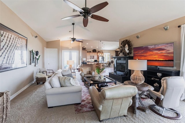 3712 Balboa Ct, Punta Gorda, FL 33983 - carpeted living room featuring a ceiling fan, vaulted ceiling, baseboards, and a fireplace