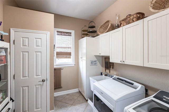 3712 Balboa Ct, Punta Gorda, FL 33983 - clothes washing area with radiator, cabinet space, light tile patterned floors, washing machine and dryer, and baseboards