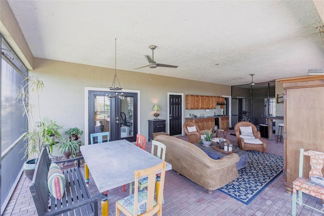 3712 Balboa Ct, Punta Gorda, FL 33983 - living area with a ceiling fan, a textured ceiling, french doors, brick patterned floors, and baseboards