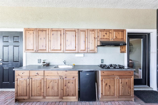 3712 Balboa Ct, Punta Gorda, FL 33983 - kitchen with a sink, under cabinet range hood, black gas stovetop, and a textured ceiling