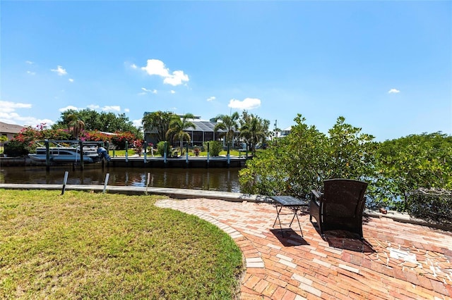 3712 Balboa Ct, Punta Gorda, FL 33983 - dock area with a water view, a lawn, and a patio area