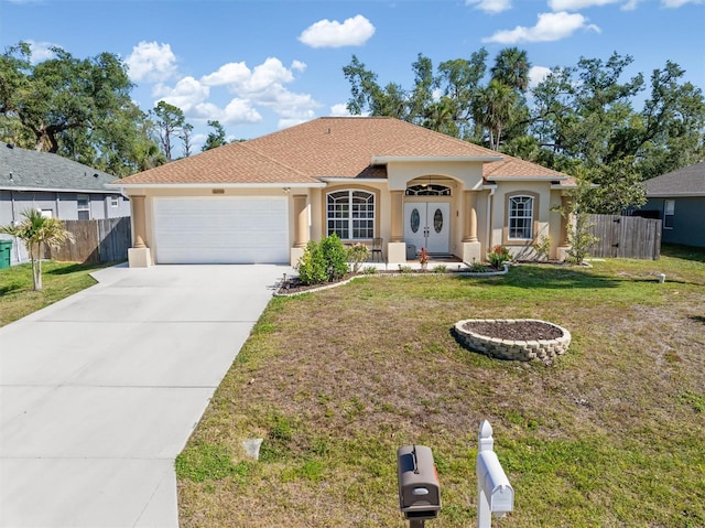 16450 Bauers Ave, Port Charlotte, FL 33954 - view of front of home with fence, a garage, stucco siding, and concrete driveway
