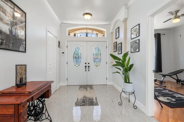 16450 Bauers Ave, Port Charlotte, FL 33954 - foyer featuring marble finish floor, crown molding, ceiling fan, and baseboards