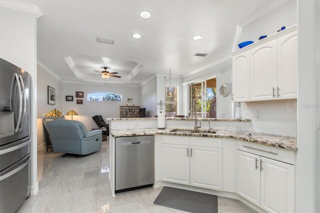 16450 Bauers Ave, Port Charlotte, FL 33954 - kitchen with visible vents, a sink, ceiling fan, appliances with stainless steel finishes, and a peninsula