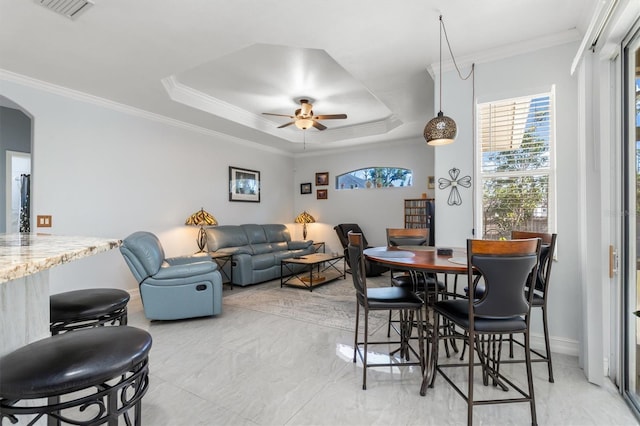 16450 Bauers Ave, Port Charlotte, FL 33954 - dining area featuring crown molding, visible vents, a tray ceiling, ceiling fan, and arched walkways