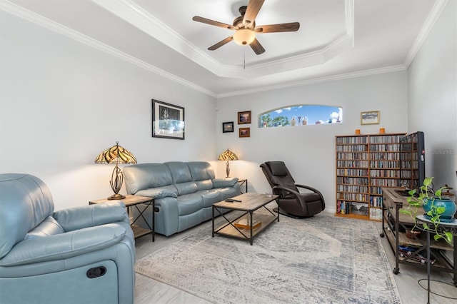 16450 Bauers Ave, Port Charlotte, FL 33954 - living room with wood finished floors, a ceiling fan, ornamental molding, and a raised ceiling