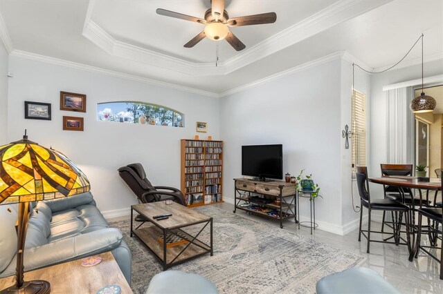 16450 Bauers Ave, Port Charlotte, FL 33954 - living room featuring crown molding, ceiling fan, a raised ceiling, and baseboards