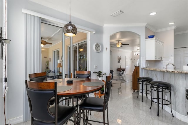 16450 Bauers Ave, Port Charlotte, FL 33954 - dining area featuring marble finish floor, crown molding, ceiling fan, and visible vents