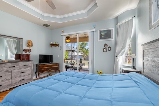 16450 Bauers Ave, Port Charlotte, FL 33954 - bedroom with a raised ceiling, ornamental molding, ceiling fan, wood finished floors, and access to exterior