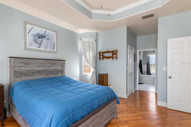 16450 Bauers Ave, Port Charlotte, FL 33954 - bedroom featuring crown molding, visible vents, baseboards, and wood finished floors
