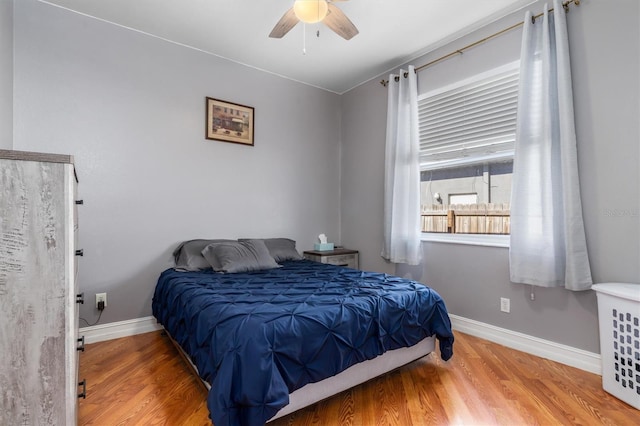 16450 Bauers Ave, Port Charlotte, FL 33954 - bedroom with wood finished floors, baseboards, and a ceiling fan