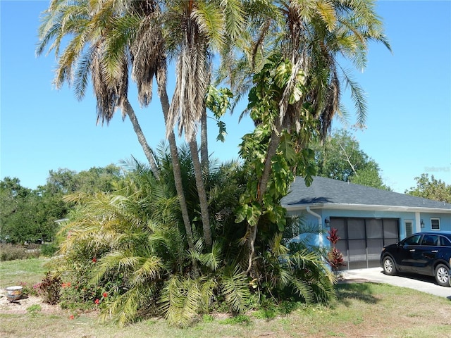 1233 Dewhurst St, Port Charlotte, FL 33952 - view of property exterior with an attached garage and concrete driveway