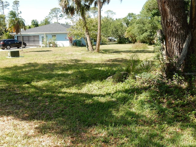 1233 Dewhurst St, Port Charlotte, FL 33952 - view of yard with a garage