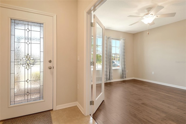 entryway with ceiling fan, baseboards, and wood finished floors