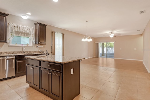 kitchen featuring stainless steel dishwasher, light tile patterned floors, a sink, open floor plan, and ceiling fan with notable chandelier