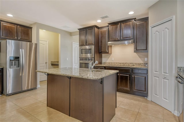 kitchen featuring under cabinet range hood, visible vents, stainless steel appliances, and light tile patterned floors