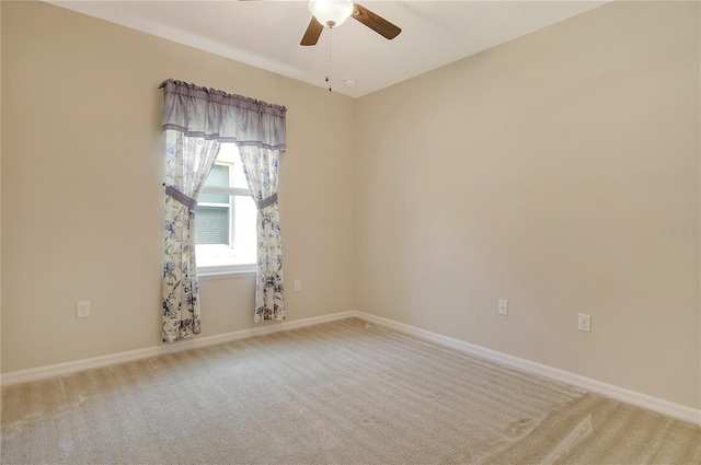 unfurnished room featuring carpet flooring, a ceiling fan, and baseboards