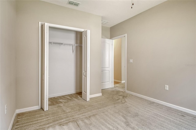 unfurnished bedroom featuring a closet, carpet floors, visible vents, and baseboards