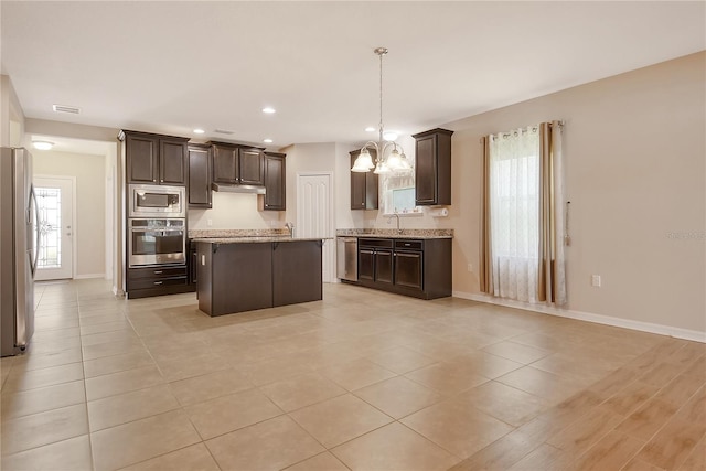 kitchen featuring baseboards, dark brown cabinetry, a chandelier, and stainless steel appliances