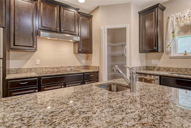 kitchen with a sink, dishwasher, dark brown cabinetry, black electric cooktop, and under cabinet range hood