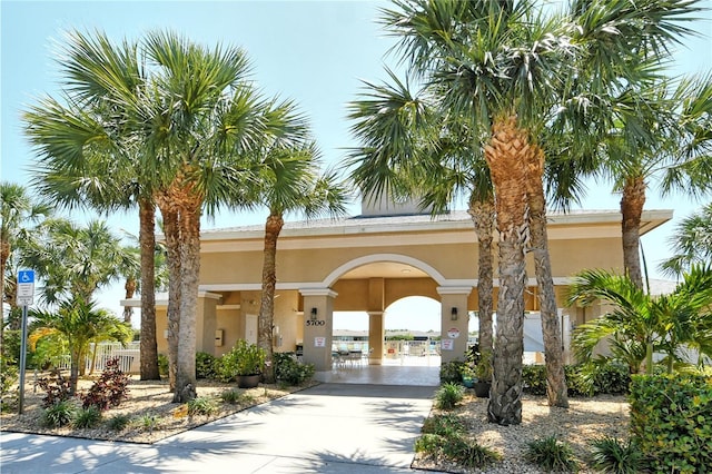 view of property's community featuring concrete driveway