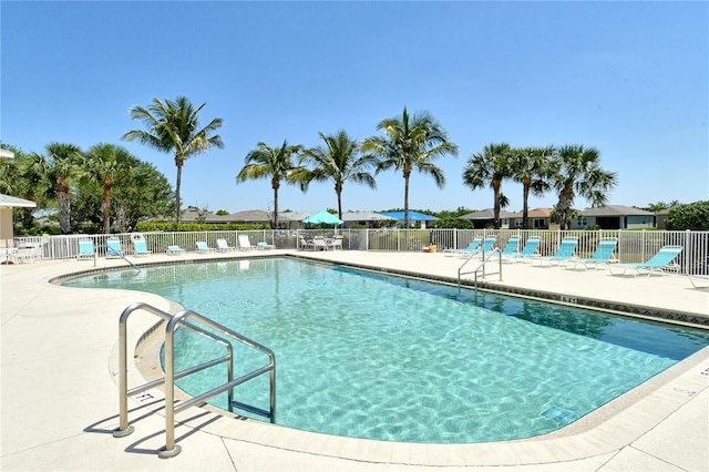 pool with fence and a patio area